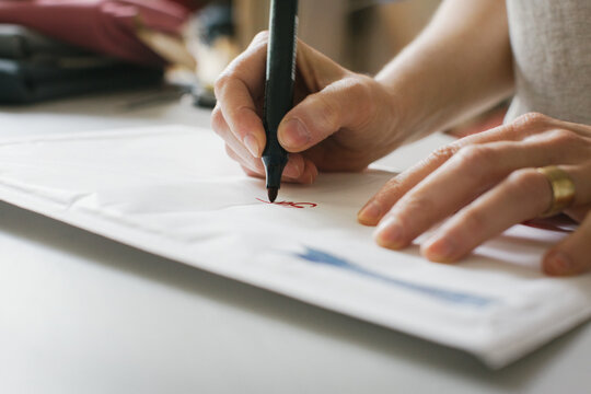 Close Up of Caucasian Woman Writing Address With Red Marker on White Envelope