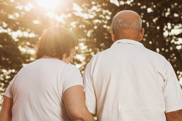 elderly couple walking at sunset