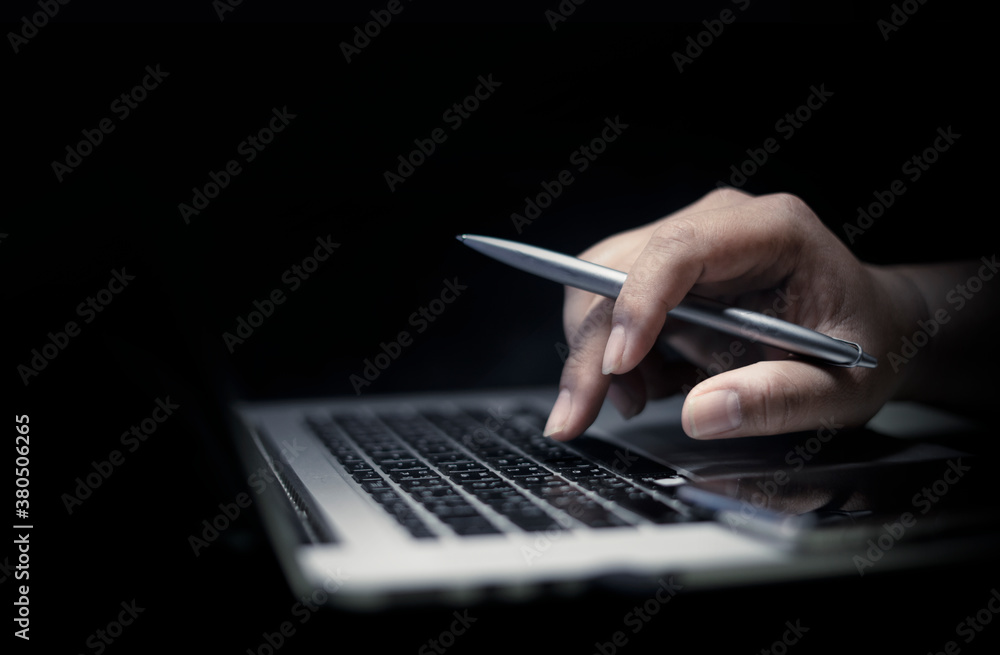 Poster man using laptop or computer working at home in the at night for web banner with copy space.