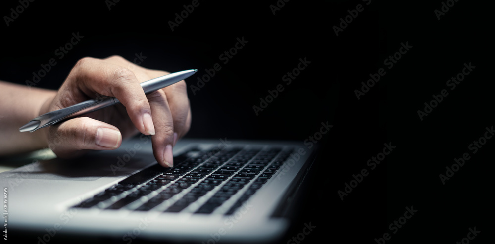 Aufkleber man using laptop or computer working at home in the at night for web banner with copy space.
