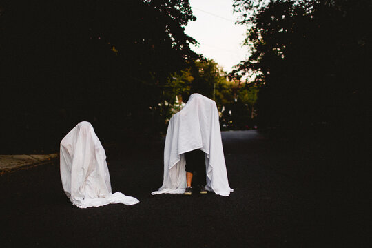 two children dressed in ghost costumes for halloween
