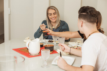 people smiling, talking and eating beans