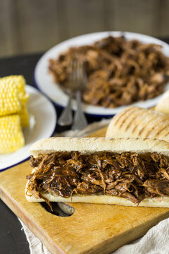 Shredded pulled beef in a panini bread roll sandwich
