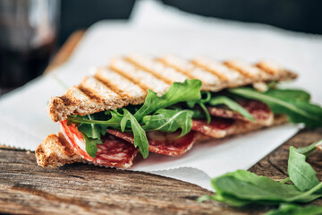 Food: Grilled sandwich with salami and rocket salad