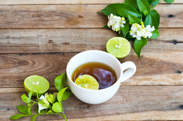 herbal healthy drinks hot lemon tea health care for cough sore with lemon slice ,jasmine flowers of lifestyle relax arrangement flat lay style on background wooden