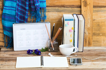 dictionary book ,mobile phone ,calendar  for study with blue scarf ,lamplight ,coffee of lifestyle...