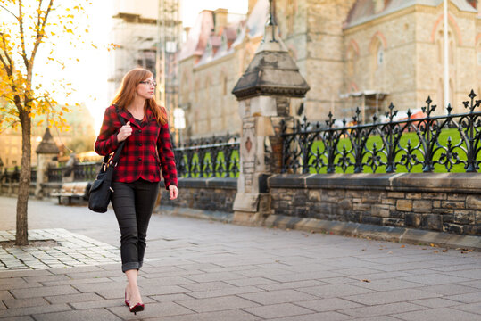 Stylish Canadian Woman Walking On Street In Front of Parliament Hill Ottawa Canada
