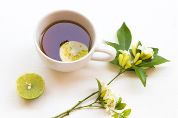herbal healthy drinks hot lemon tea health care for cough sore with lemon slice ,jasmine flowers of lifestyle relax arrangement flat lay style on background wooden
