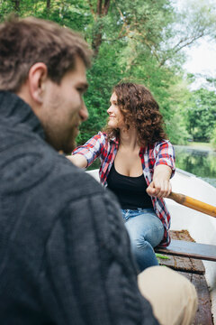 Young Caucasian Couple on Rowboat on Forest Lake