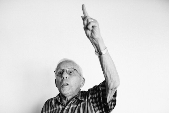 Serious older man on white studio background