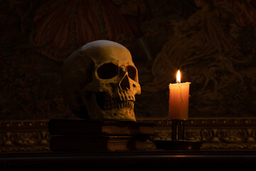 Still life type a scene with human skull and candle