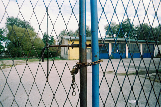 Locked gate of abandoned factory
