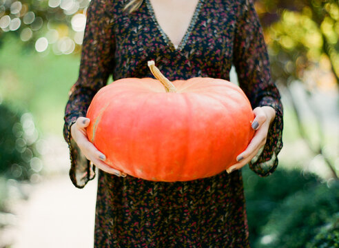Girl with an orange pumpkin