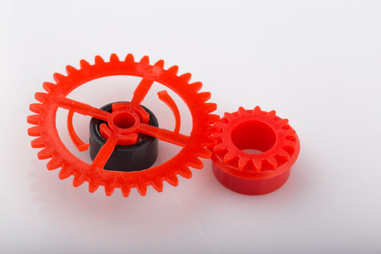 Mechanism made of red and plastic gearwheel.