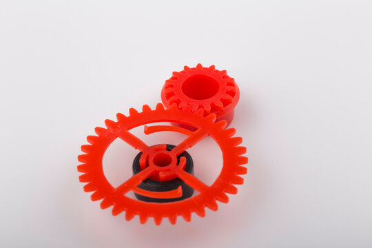 Mechanism made of red and plastic gearwheel.