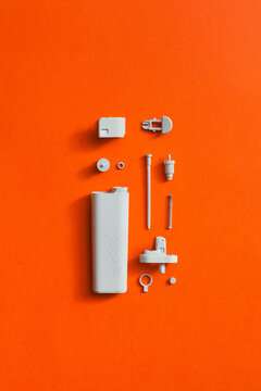 White disassembled lighter on orange/red background