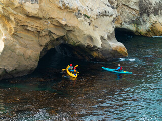 Kayakers Exploring Sea Caves on California Coast