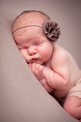 Newborn Baby Girl Sleeping Peacefully, Wearing Flower Headband