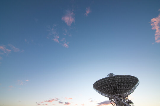 Large radio telescope at sunset