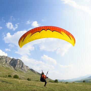 Paraglider keeping his canopy above his head