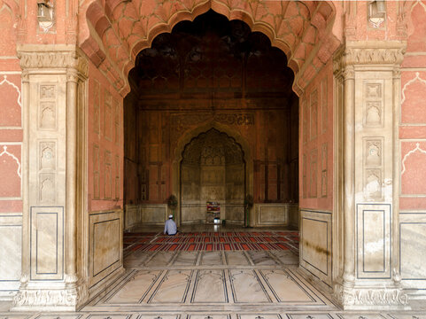 Man praying alone at the Jama Masjid Mosque, old Delhi, India