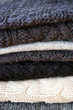 A Close Up Of A Group Of Gray Knit Sweaters
