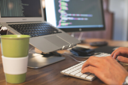 Hands on a wireless keyboard at work.