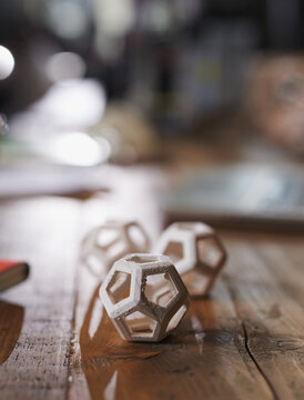 3d printed hexagon design sample on engineer wooden desk with soft white lighting