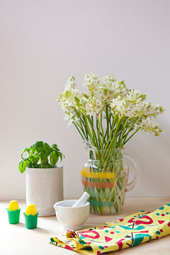 Tableau or kitchen vignette with flowers and basil and utensils