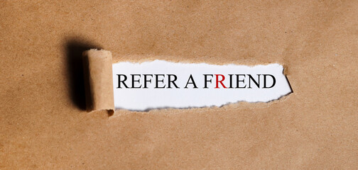 referal a friend. Text on white paper on torn paper