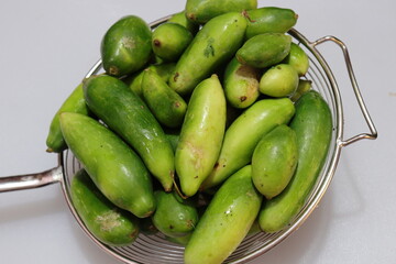 Organic Raw green Coccinia grandis or Ivy gourd on a white background