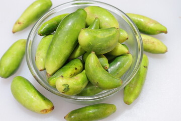 Organic Raw green Coccinia grandis or Ivy gourd on a white background