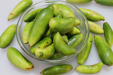Organic Raw green Coccinia grandis or Ivy gourd on a white background