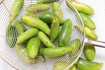 Organic Raw green Coccinia grandis or Ivy gourd on a white background