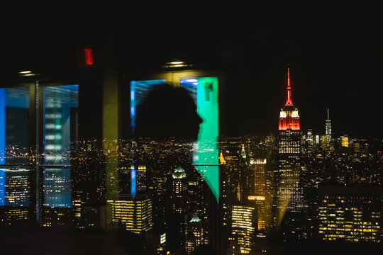 Woman on the top of NY by night