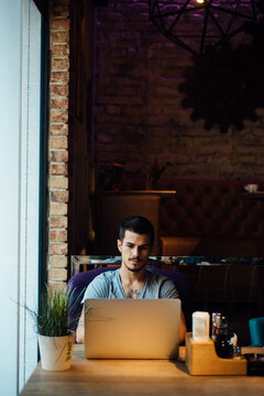 Man using a laptop in a cafe