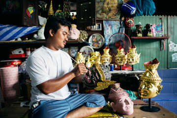 Local artist painting 'Hua Khon' traditional mask for Thai performing arts