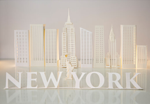 New York written with serif letters with Statue of Liberty in the middle and skyscrapers