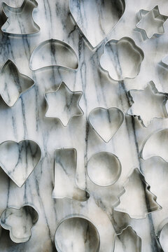 Christmas cookie cutters on marble background.