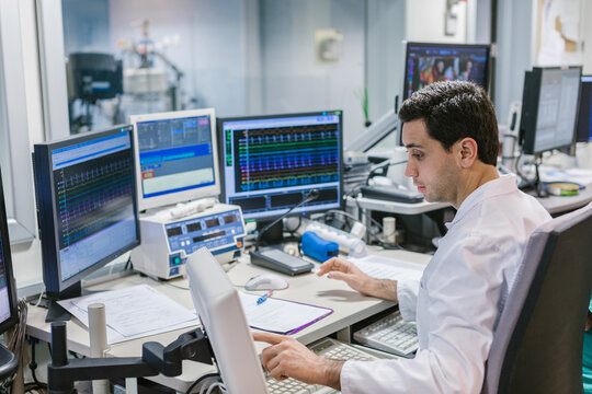 Medical Assistant Working with the Robotic Surgery Equipment Software