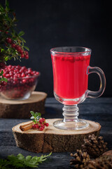 Hot lingonberry tea with cinnamon with copy space, rustic background
