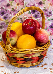 Fruit in a basket on the kitchen table close-up.
