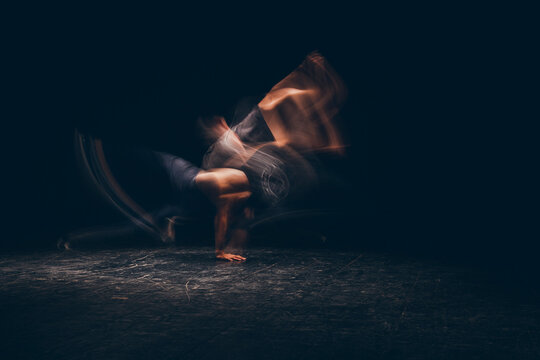 Motion blurred man breakdancing