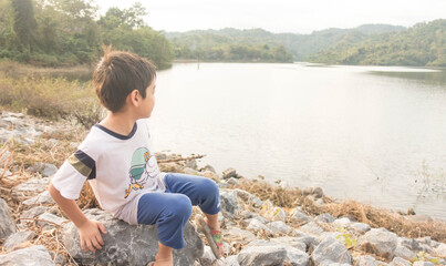 Little boy travelling at dam nature trip with family