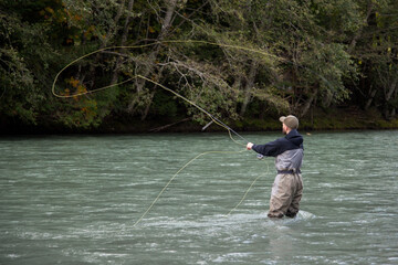 Squamish, British-Columbia / Canada - 09/23/2020: A Fly Fisherman casts his line for a fish on the Squamish River