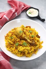 Chicken Biryani/murg Pulao. Garnished with fried onion & chopped coriander. Biryani raita is a famous Spicy non vegetarian dish of India. Chicken cooked along with Basmati rice & spices. copy space.