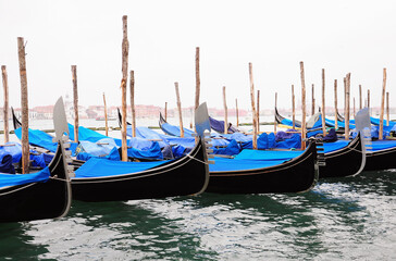 Fototapeta premium Gondolas moored docked on water in Venice.
