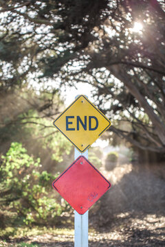 End sign at the end of a sunlit road