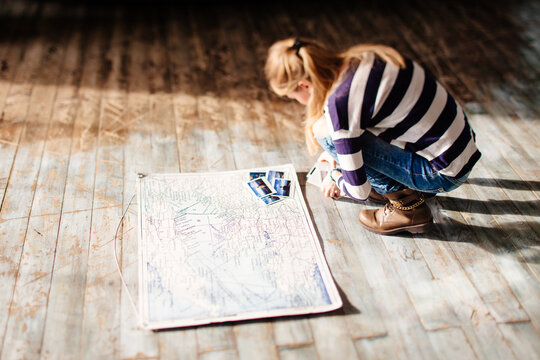 Woman sitting next to world map