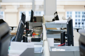 Close crop of empty desks in trendy office space